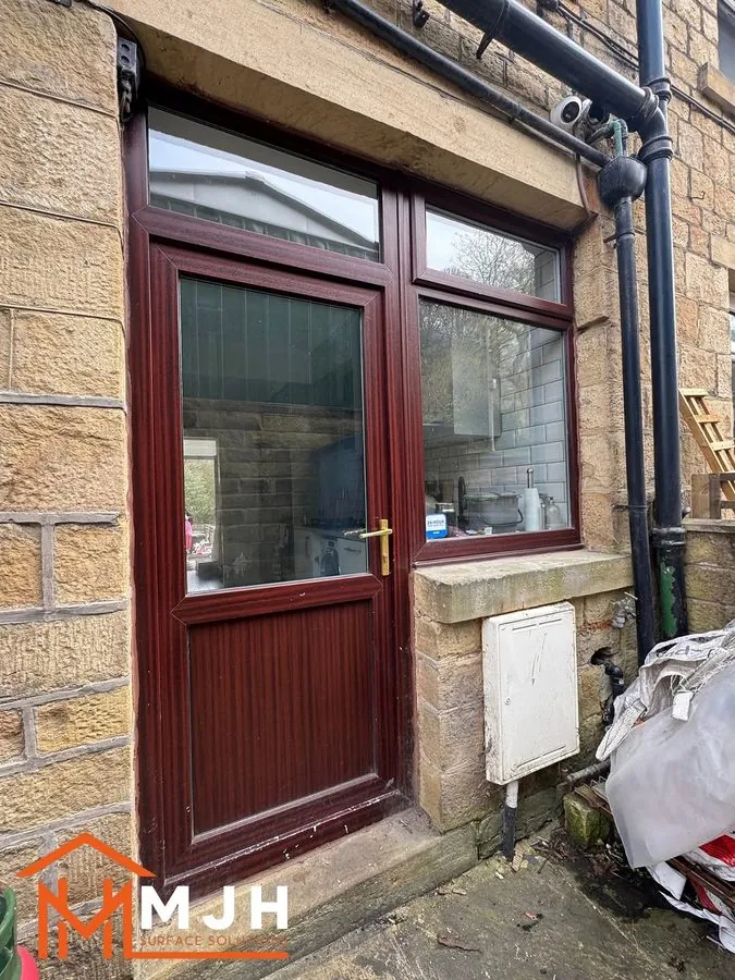 Back door and kitchen window in maroon uPVC before spraying
