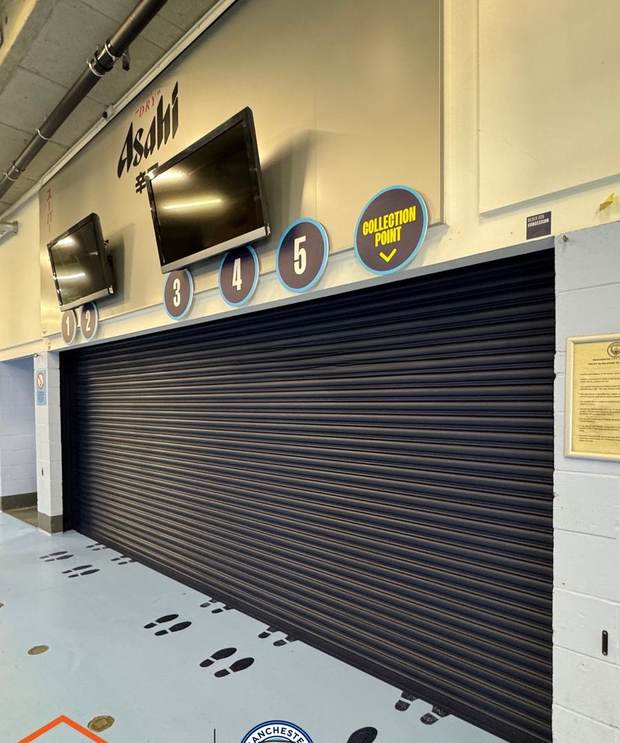 The same roller shutter after spraying in dark charcoal