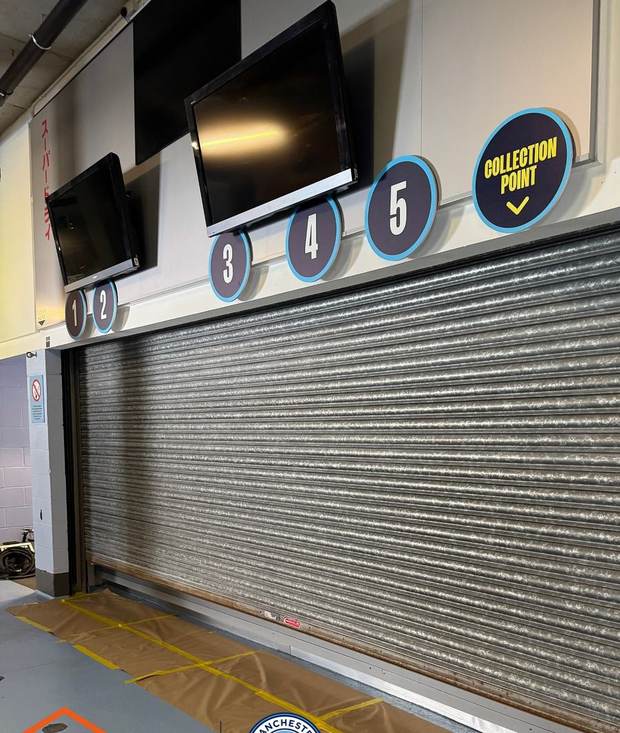 Roller shutter before spraying, bare galvanised steel with the floor masked out