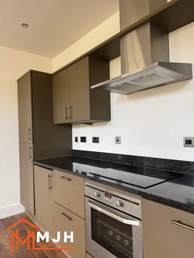 Sprayed kitchen units around an extractor hood and hob