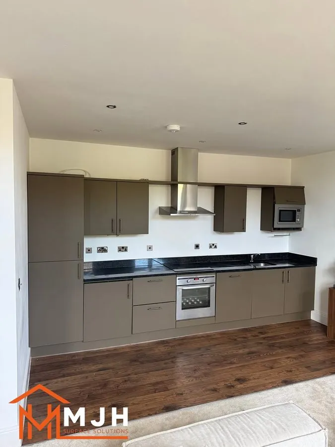 Kitchen units sprayed olive-grey with black granite worktops