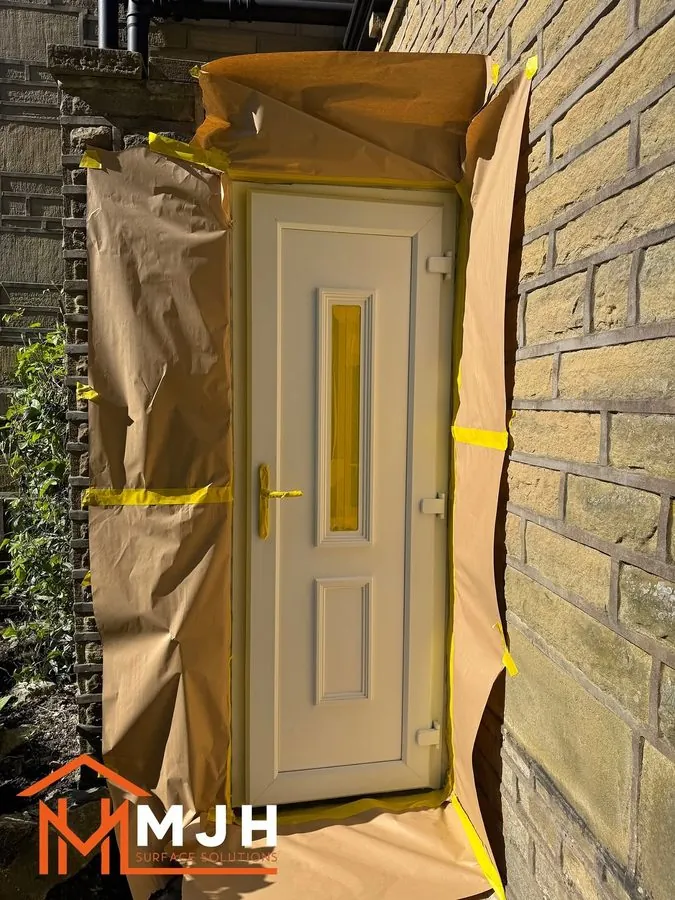 uPVC front door fully masked with paper and tape before spraying